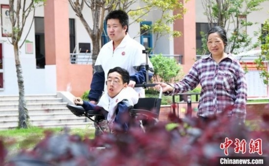 碰上天氣好，朱金祥就會利用休息時間，和鐘華強母親將其推出來賞賞花，曬曬太陽，呼吸一下外面的新鮮空氣。 卓忠偉 攝