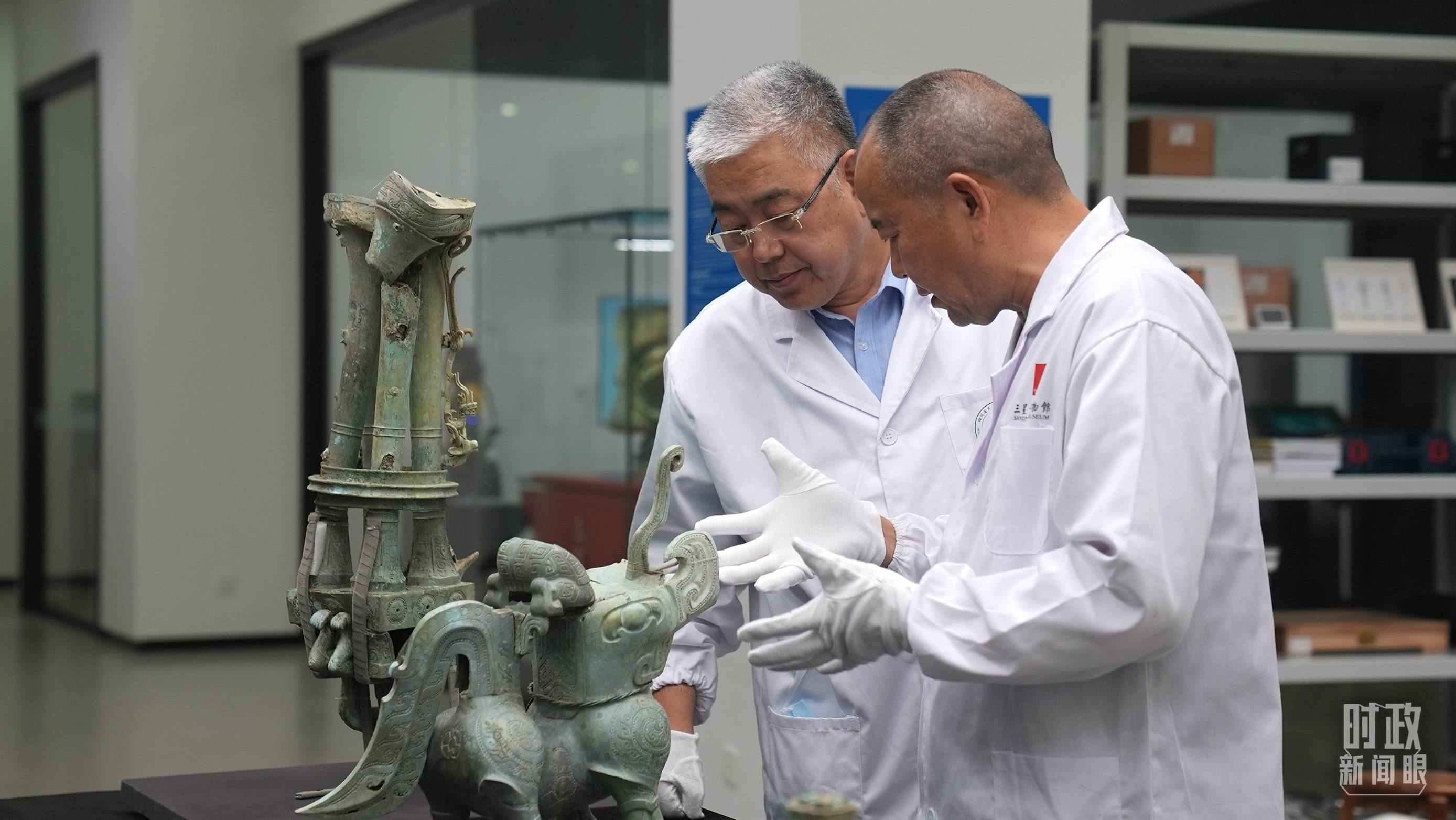 △三星堆文保專家正在就修復(fù)方案進行討論。（總臺央視記者劉琦拍攝）