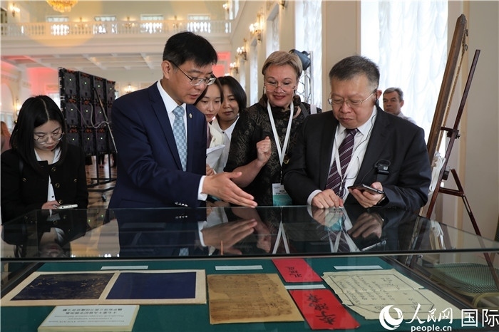 中俄圖書館論壇嘉賓共同參觀由俄羅斯國立列寧圖書館舉辦的館藏中國古籍善本圖書展。人民網(wǎng)記者 隋鑫攝）