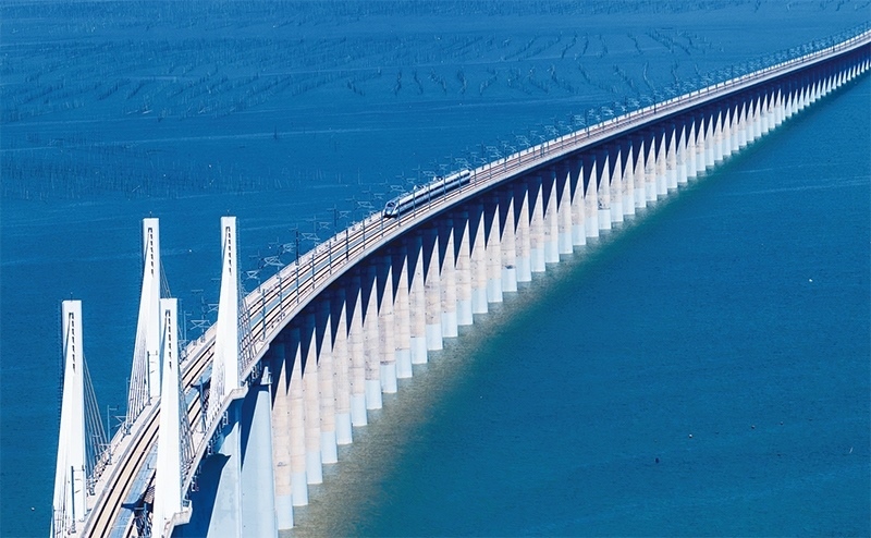 2023年9月28日，中國首條時速350公里跨海高鐵——福廈高鐵正式開通運營。圖為一列運行試驗車組駛過福廈高鐵湄洲灣跨海大橋（9月19日攝，無人機(jī)照片）。 新華社記者 魏培全/攝