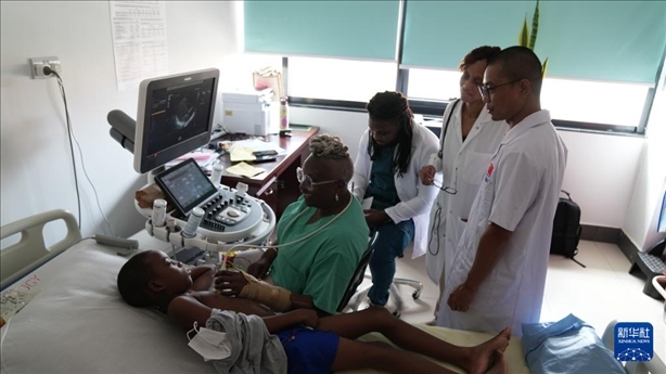 3月4日，在多米尼克羅索的中多友誼醫(yī)院，援多醫(yī)療隊成員、南方醫(yī)科大學第五附屬醫(yī)院心血管內(nèi)科主治醫(yī)師駱志鵬與當?shù)蒯t(yī)生共同診療。新華社記者 王朝 攝