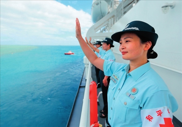 中國海軍“和平方舟”號(hào)醫(yī)院船結(jié)束訪問湯加時(shí)，任務(wù)官兵中的文職人員向歡送人群揮手告別（2023年8月4日攝）。徐巍攝/本刊