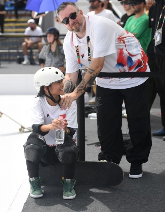 6月20日，鄭好好（左）在比賽間隙與教練互動，她在預(yù)賽中最佳成績?yōu)?2.60分。當(dāng)日，巴黎奧運(yùn)會資格系列賽布達(dá)佩斯站滑板女子碗池預(yù)賽在布達(dá)佩斯舉行。新華社記者 賀燦鈴 攝