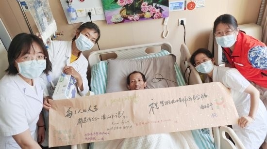 7月26日，海淀醫(yī)院安寧療護(hù)科醫(yī)護(hù)團(tuán)隊(duì)為朱銳送來一條寫滿祝福的橫幅。（受訪者供圖）
