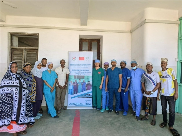 隊(duì)長(zhǎng)蔣國(guó)慶（右七）和手術(shù)醫(yī)生、部分患者合影。中國(guó)援桑醫(yī)療隊(duì)供圖