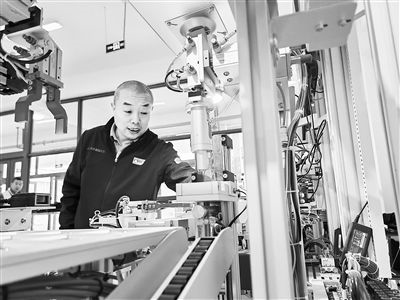 郭海青在檢查車床加工設(shè)備。 受訪者供圖