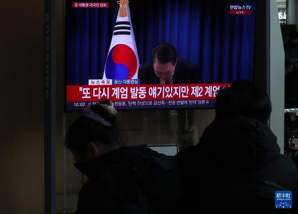 12月7日，在韓國首爾火車站，民眾觀看總統(tǒng)尹錫悅發(fā)表講話的電視畫面。新華社記者 姚琪琳 攝