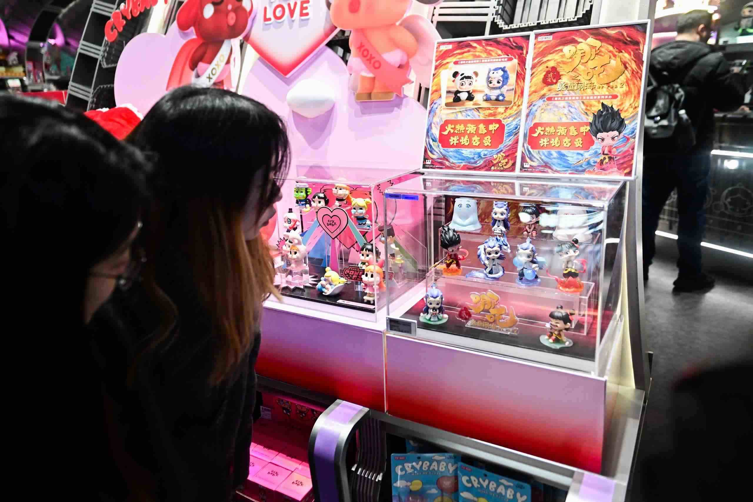 △2025年2月22日，上海，市民在圍觀《哪吒之魔童鬧?！废嚓P(guān)手辦盲盒。